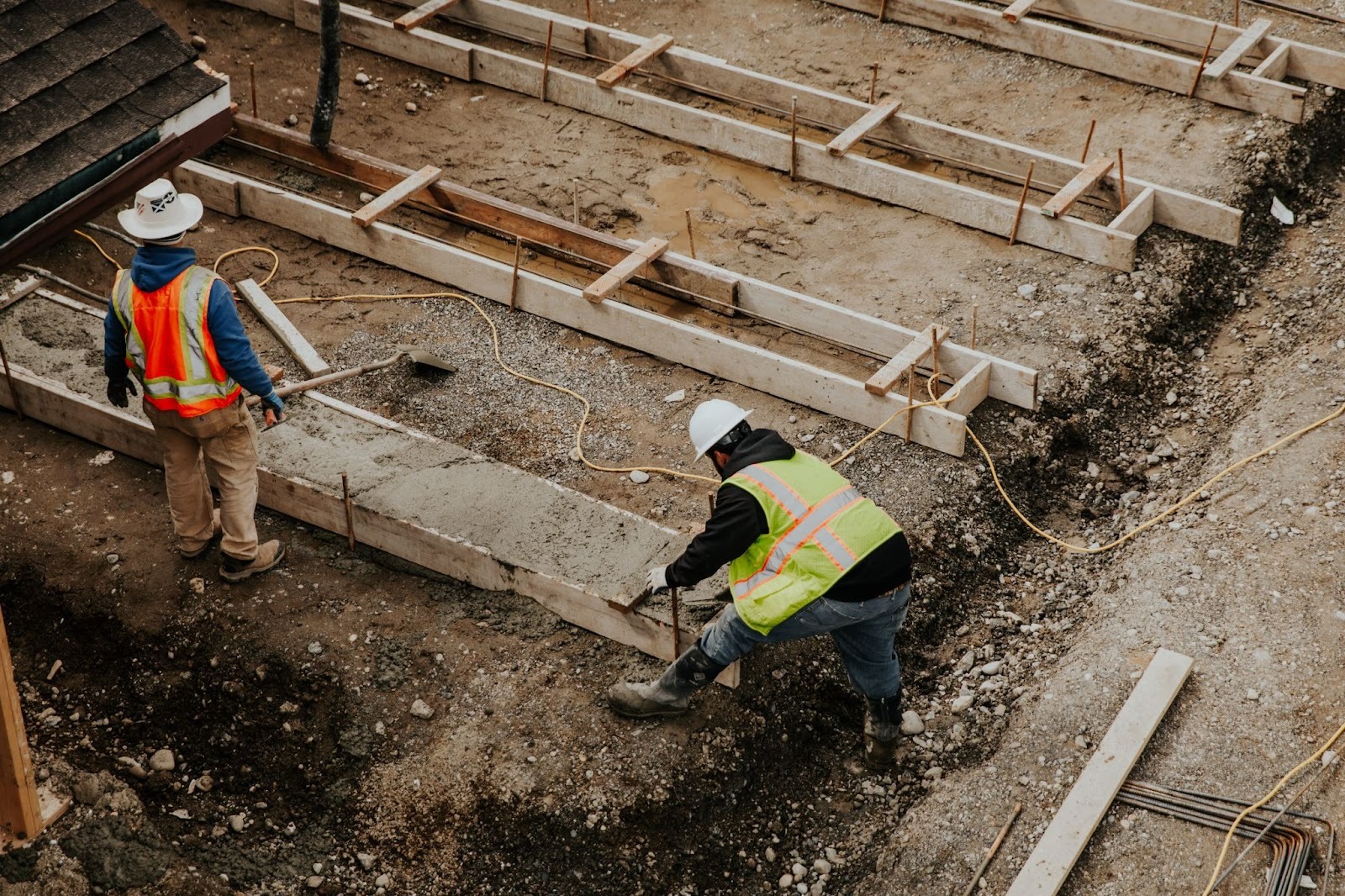 A concrete foundation contractor’s crew prepares a site for building.