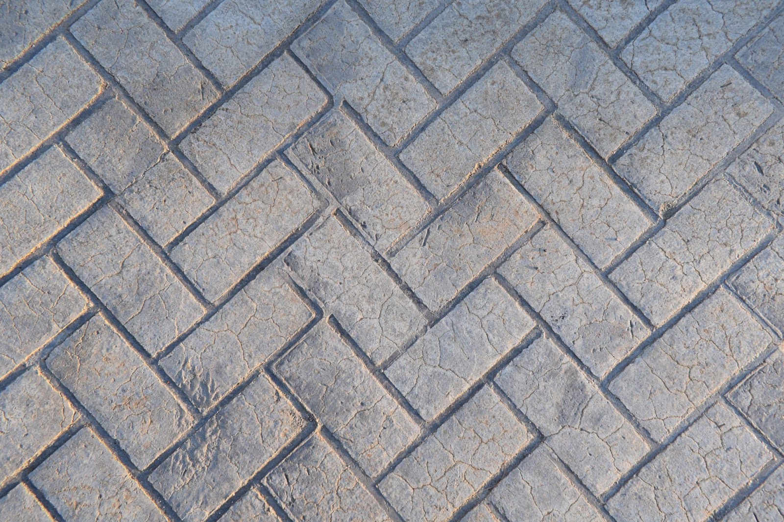 Stamped concrete made to look like gray bricks.